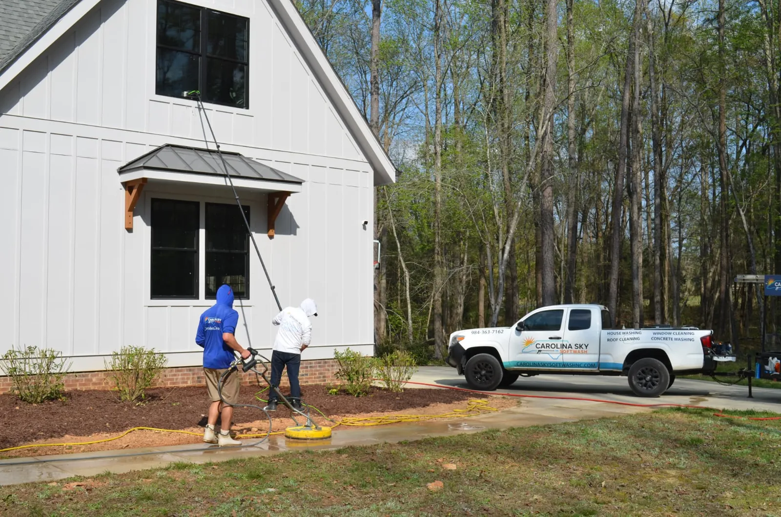 HOA sidewalk and window cleaning with the Carolina Sky truck on site